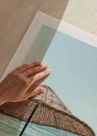 Poster with a photograph of a beautiful parasol by a beach-9