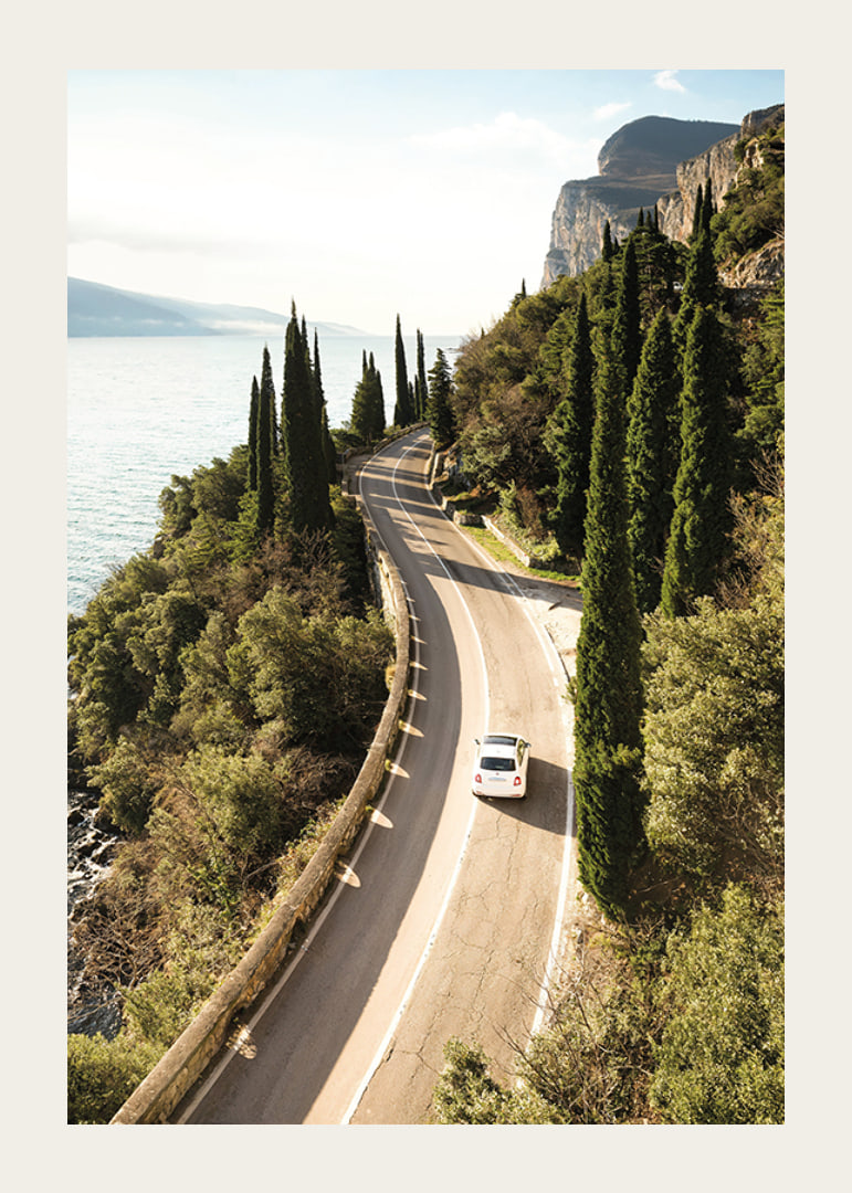 Poster with a photograph of a winding road on a coastline-12