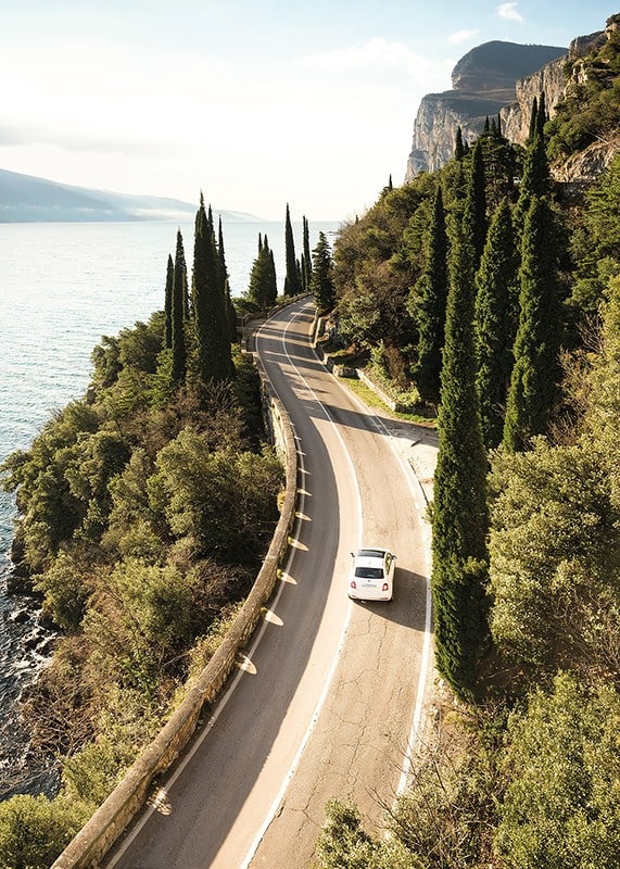 Poster with a photograph of a winding road on a coastline-12