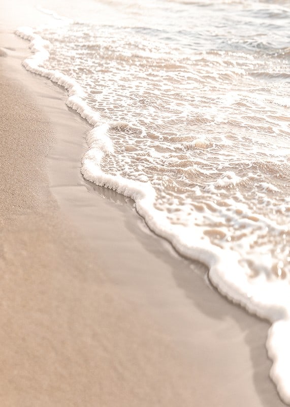 Poster with a photograph that captures the soft waves of the sea rolling in over the golden sand.-12