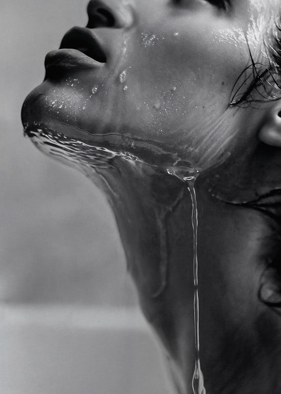 Black and white poster with a sensual photograph of a model with running water-12
