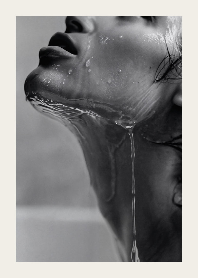 Black and white poster with a sensual photograph of a model with running water-12