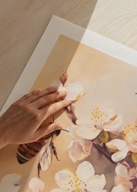 En poster med bin som arbetar bland blommande grenar i mjukt gyllene ljus-5