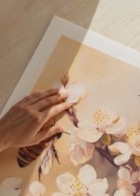 En poster med bin som arbetar bland blommande grenar i mjukt gyllene ljus-5