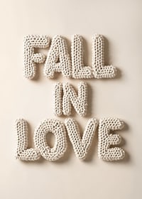 Poster with the text "Fall in love" written in crocheted letters-7
