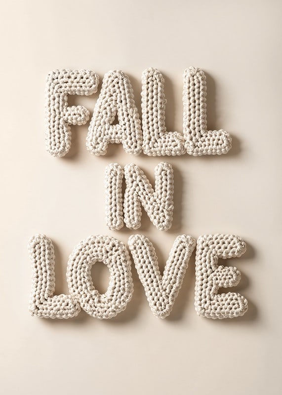 Poster with the text "Fall in love" written in crocheted letters-12