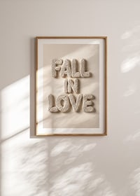 Poster with the text "Fall in love" written in crocheted letters-8