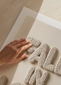 Poster with the text "Fall in love" written in crocheted letters-9