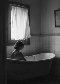 A poster with a woman sitting in her bathtub and thinking-7