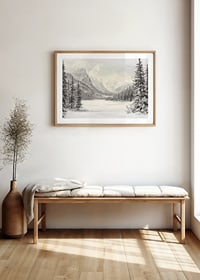 A poster of snow-capped mountains and a peaceful valley, framed by stately firs-8