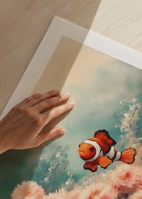 A poster of a vibrant clownfish swimming among soft, flower-like corals-9