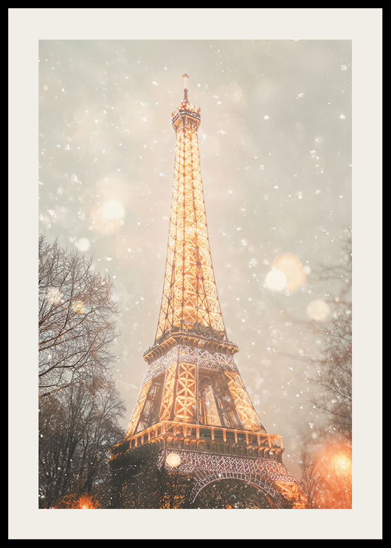 Un poster invernale con la Torre Eiffel che illumina una Parigi innevata con una luce dorata.-12