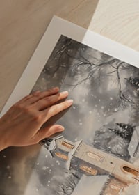 A poster with an illuminated church in a snow-covered winter landscape.-9