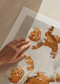 A Christmas poster with happy gingerbread men playing in the snow spreads joy.-9