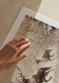 A poster of reindeer galloping through a snow-covered landscape.-9