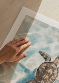 A poster of a sea turtle gliding through crystal clear water-9