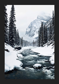 A calm river meanders through a snow-covered forest, surrounded by high mountains and the quiet beauty of winter-5