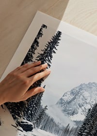 A calm river meanders through a snow-covered forest, surrounded by high mountains and the quiet beauty of winter-9