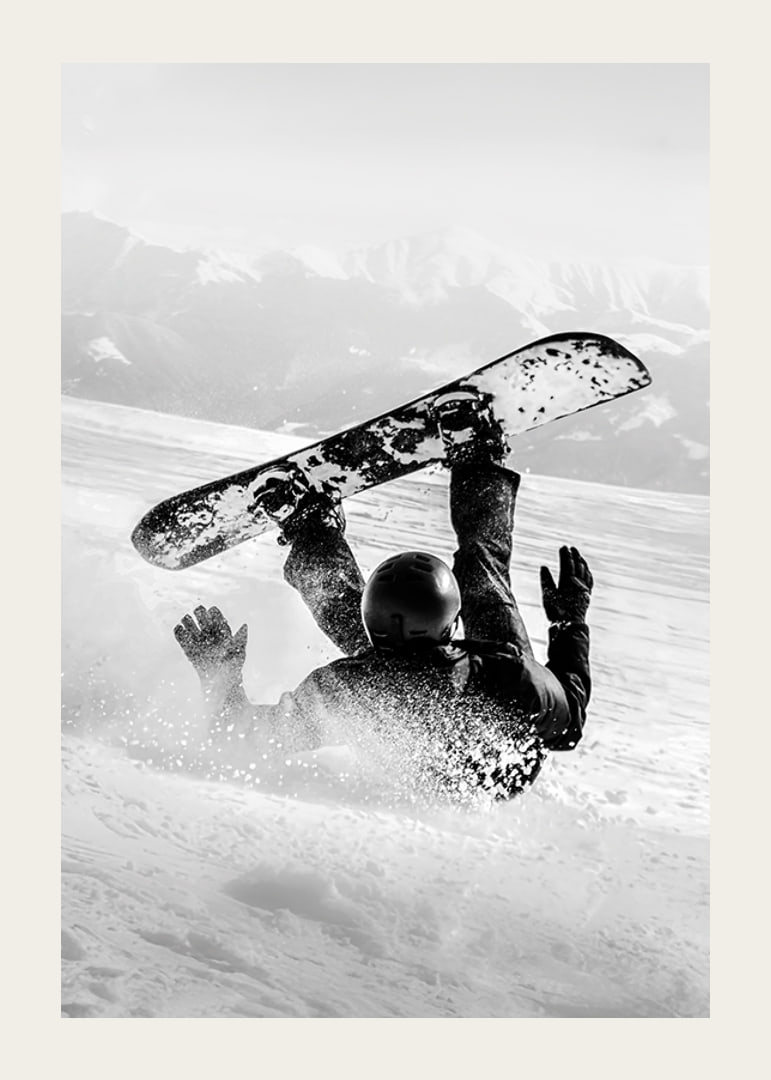 A dramatic moment of snowboarding adventure where a skier meets both speed and fall in snow-covered mountains.-12