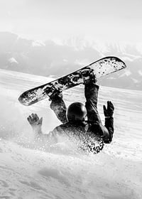 A dramatic moment of snowboarding adventure where a skier meets both speed and fall in snow-covered mountains.-7