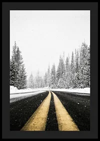 A desolate winter road winds through a snow-covered forest-4
