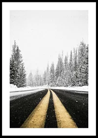 A desolate winter road winds through a snow-covered forest-0
