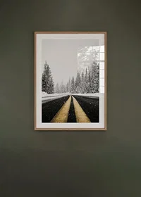 A desolate winter road winds through a snow-covered forest-8