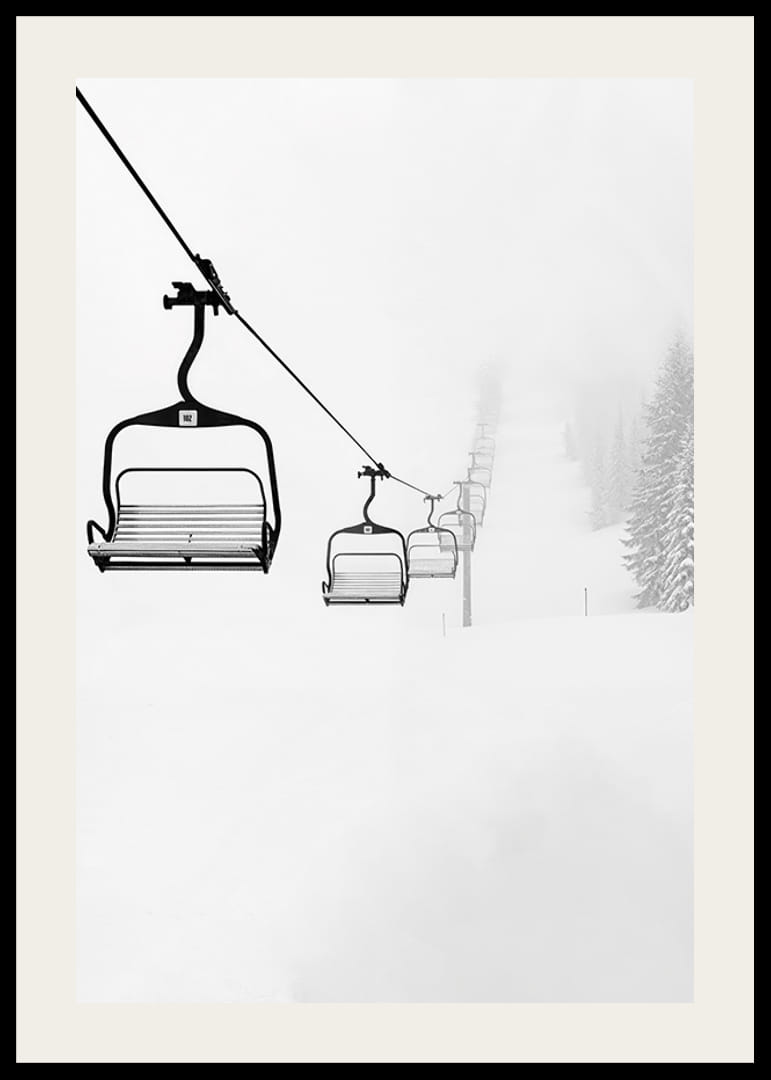 An empty ski lift stretches through a snow-covered landscape, capturing the quiet and peaceful beauty of winter-12