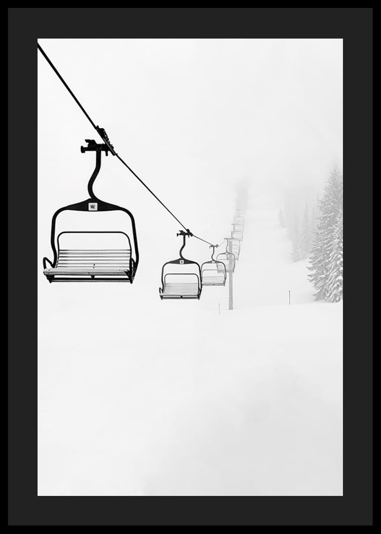 An empty ski lift stretches through a snow-covered landscape, capturing the quiet and peaceful beauty of winter-12