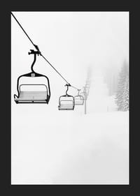 An empty ski lift stretches through a snow-covered landscape, capturing the quiet and peaceful beauty of winter-5