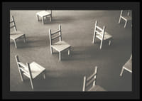 En minimalistisk bild av tomma stolar spridda över ett golv, som symboliserar stillhet och utrymme för eftertanke-4