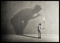 A symbolic image of facing one's inner demons, where a small torch casts a large, confrontational shadow-6