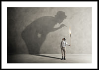 A symbolic image of facing one's inner demons, where a small torch casts a large, confrontational shadow-0