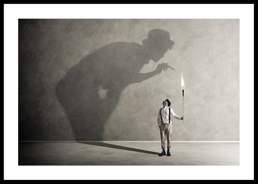 A symbolic image of facing one's inner demons, where a small torch casts a large, confrontational shadow-12