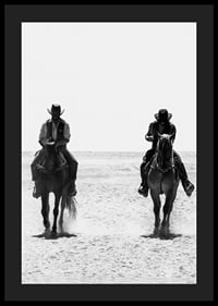 Two cowboys ride side by side through a desolate landscape, framed by the timeless mystery and freedom of the Wild West.-4