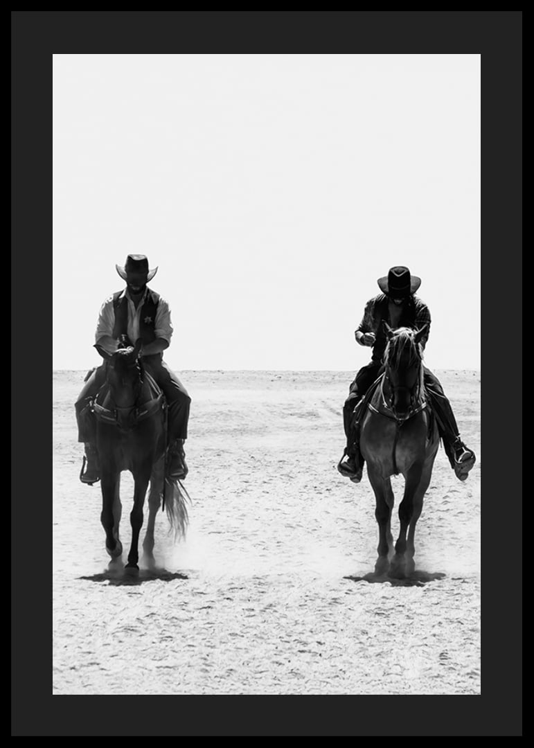 Two cowboys ride side by side through a desolate landscape, framed by the timeless mystery and freedom of the Wild West.-12