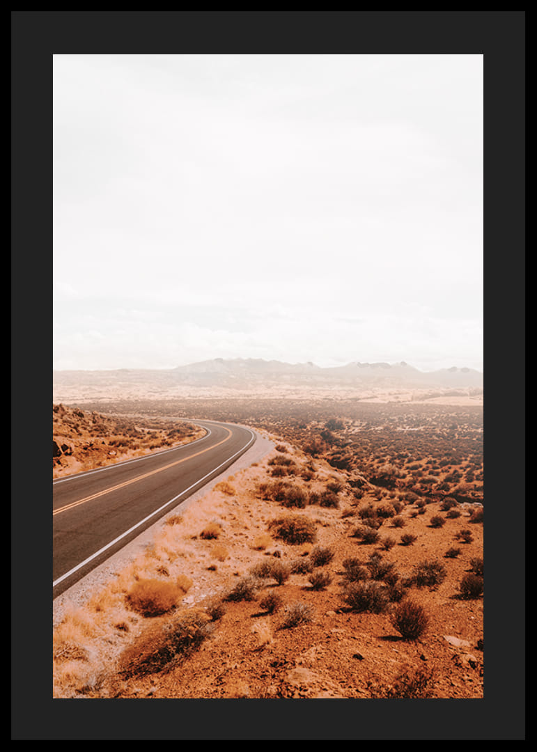 A winding road through the desert landscape that beckons with promises of adventure and freedom on the horizon.-12
