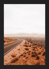 A winding road through the desert landscape that beckons with promises of adventure and freedom on the horizon.-5