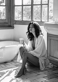 A woman sits in her bathroom with her morning cup and thinks-7