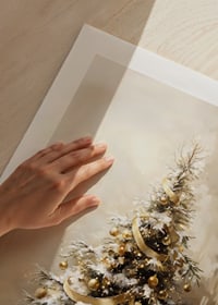 A beautiful, snow-covered Christmas tree decorated in golden tones.-9