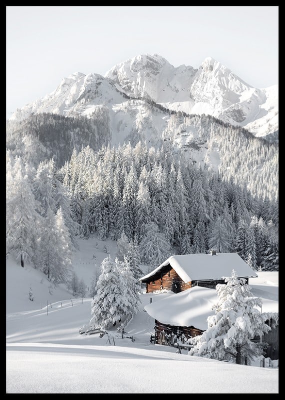 A snow-covered mountain cabin surrounded by frosty trees and majestic mountains that exudes winter idyll and tranquility.-12