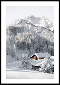 A snow-covered mountain cabin surrounded by frosty trees and majestic mountains that exudes winter idyll and tranquility.-0