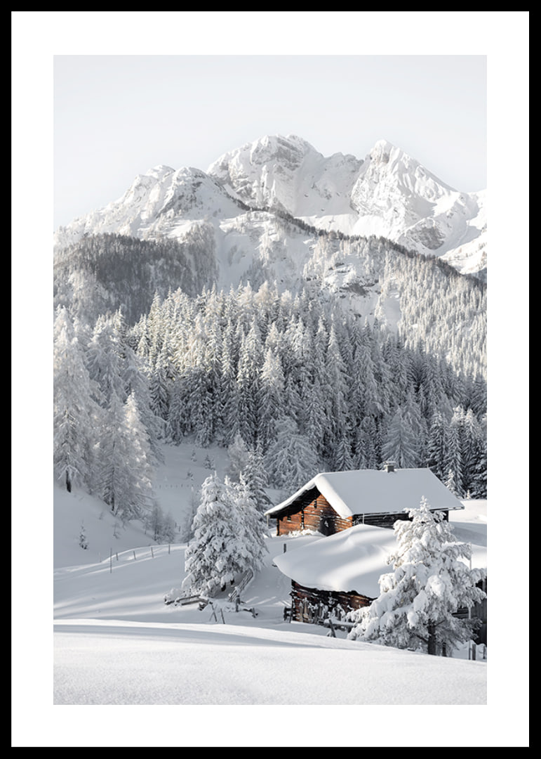 A snow-covered mountain cabin surrounded by frosty trees and majestic mountains that exudes winter idyll and tranquility.-12