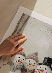 A Christmas poster with three happy snowmen who spread winter joy and community.-9