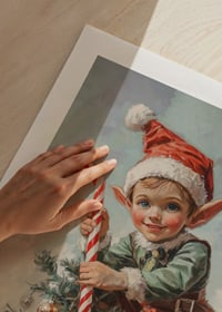 A Christmas poster with a Santa Claus sitting on a Christmas tree with a polka dot in his hand.-9