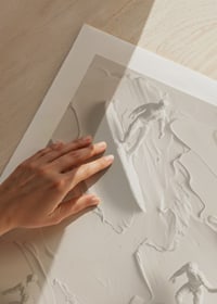A poster with textured surfers riding abstract, monochrome waves-9