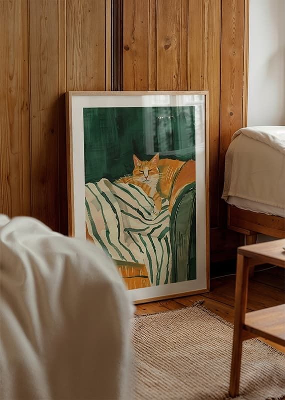 A poster of a relaxed orange cat resting on a striped blanket-12