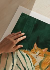 A poster of a relaxed orange cat resting on a striped blanket-5