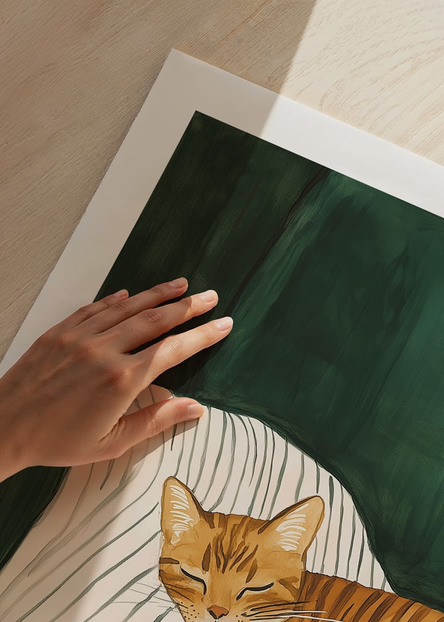 A poster of a sleeping orange tabby cat on a striped blanket in a green armchair-12