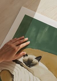 A poster of a sleeping Siamese cat on a striped blanket in a brown armchair-5